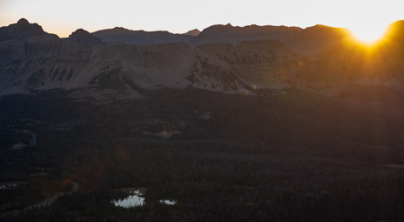 Panoramic mountain sunrise over forest and lakes