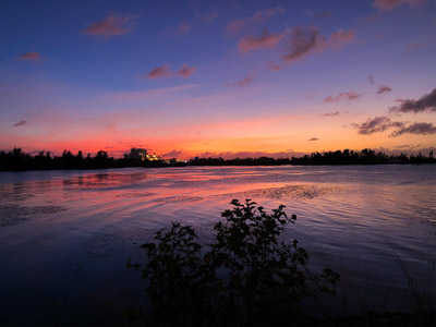 Sunset over water distant silhouette